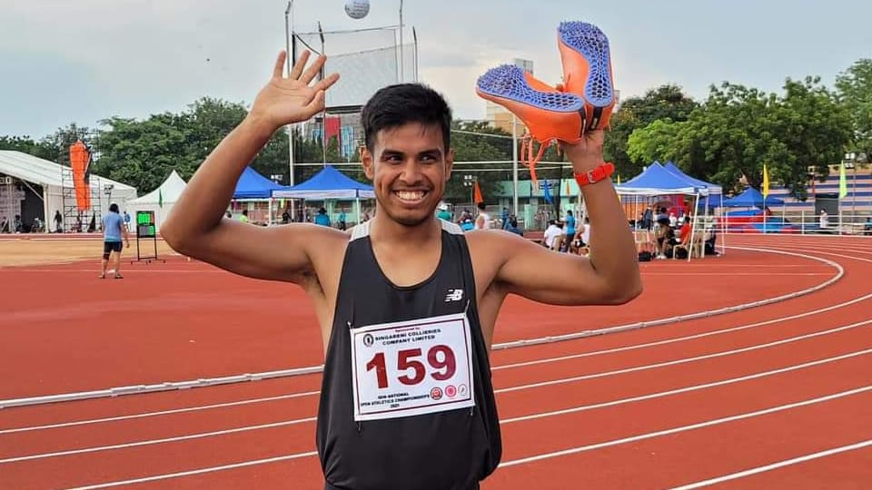 Amlan Borgohain holding running spikes