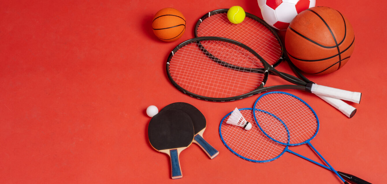 Sport equipment flat lay. Variety of rackets and balls